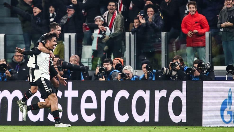 Juventus' Argentine forward Paulo Dybala (L) celebrates with Juventus' Bosnian midfielder Miralem Pjanic after opening the scoring during the UEFA Champions League Group D football match Juventus Turin vs Atletico Madrid on November 26, 2019 at the Juventus Allianz stadium in Turin. (Photo by Isabella BONOTTO / AFP) (Photo by ISABELLA BONOTTO/AFP via Getty Images)