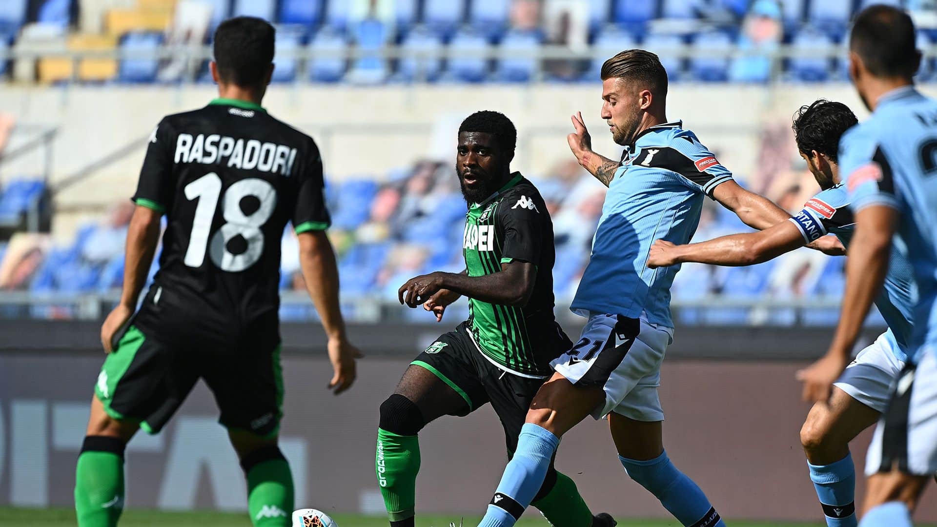 Sassuolo's Ivorian forward Jeremie Boga (C) outruns Lazio's Serbian midfielder Sergej Milinkovic-Savic during the Italian Serie A football match Lazio Rome vs Sassuolo played behind closed doors on July 11, 2020 at the Olympic stadium in Rome, as the country eases its lockdown aimed at curbing the spread of the COVID-19 infection, caused by the novel coronavirus. (Photo by Vincenzo PINTO / AFP) (Photo by VINCENZO PINTO/AFP via Getty Images)