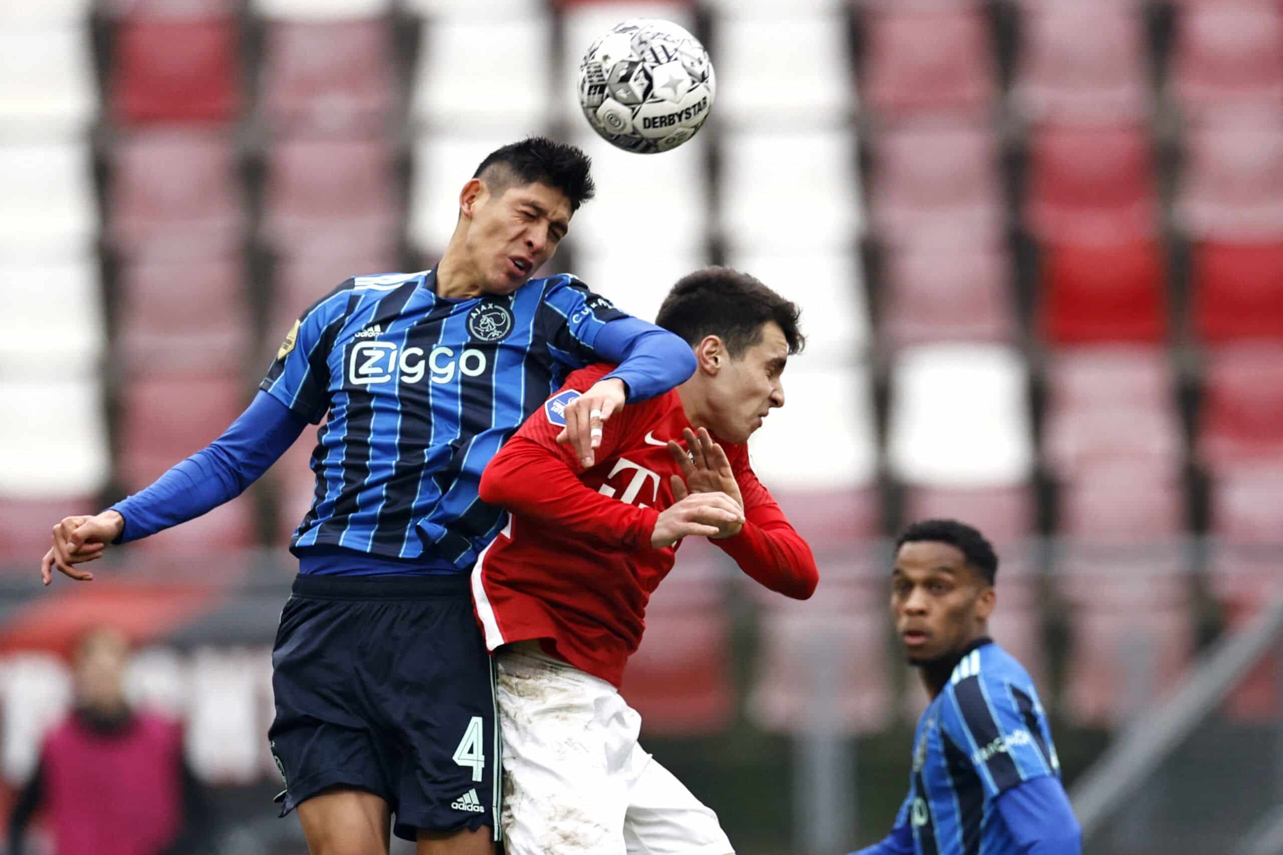 Ajax' Mexican midfielder Edson Alvarez (L), fights for the ball against FC Utrecht's Greek forward Tasos Douvikas, during the Dutch Eredivisie match between FC Utrecht and Ajax at Stadion Galgenwaard in Utrecht on January 16, 2022. - - Netherlands OUT (Photo by MAURICE VAN STEEN / ANP / AFP) / Netherlands OUT (Photo by MAURICE VAN STEEN/ANP/AFP via Getty Images)