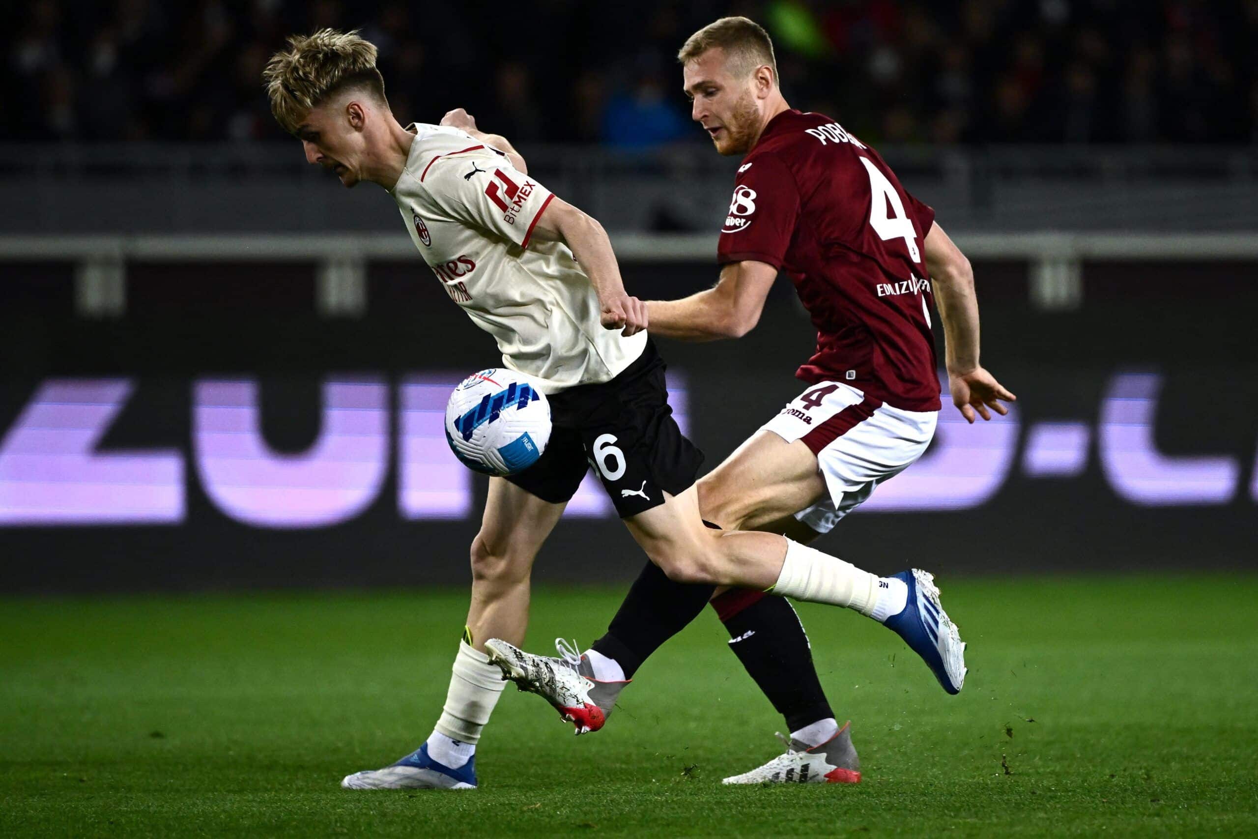 AC Milans midfielder Alexis Saelemaeker from Belgium fights for the ball with Torinos defender Lyanco from Brazil (R) during the Italian Serie A football match between Torino and AC Milan at The Olympic Stadium in Turin on April 10, 2022. (Photo by MARCO BERTORELLO / AFP) (Photo by MARCO BERTORELLO/AFP via Getty Images)