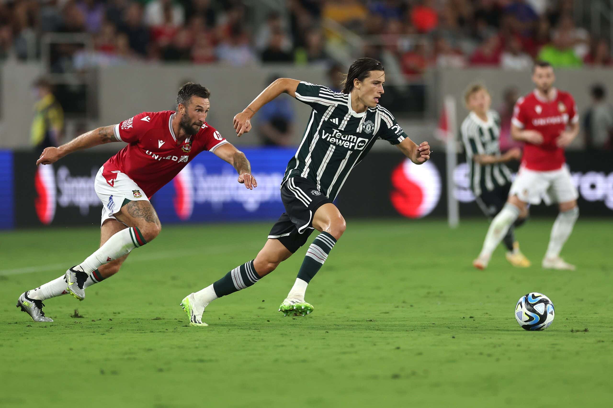 SAN DIEGO, CALIFORNIA - JULY 25:  Alvaro Fernandez #42 of Manchester United eludes the defense of Ollie Palmer #9 of Wrexham during the first half of a pre-season friendly match between Manchester United and Wrexham at Snapdragon Stadium on July 25, 2023 in San Diego, California. (Photo by Sean M. Haffey/Getty Images)