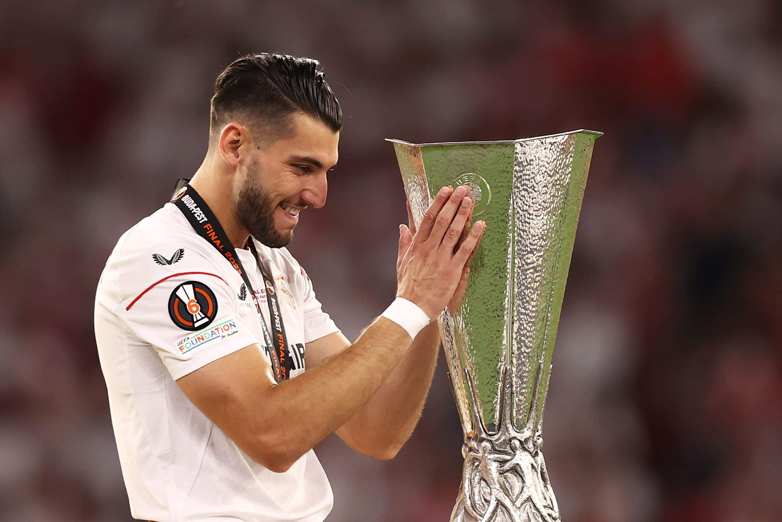 BUDAPEST, HUNGARY - MAY 31: Rafa Mir of Sevilla FC celebrates with the UEFA Europa League trophy after the team's victory in the UEFA Europa League 2022/23 final match between Sevilla FC and AS Roma at Puskas Arena on May 31, 2023 in Budapest, Hungary. (Photo by Naomi Baker/Getty Images)