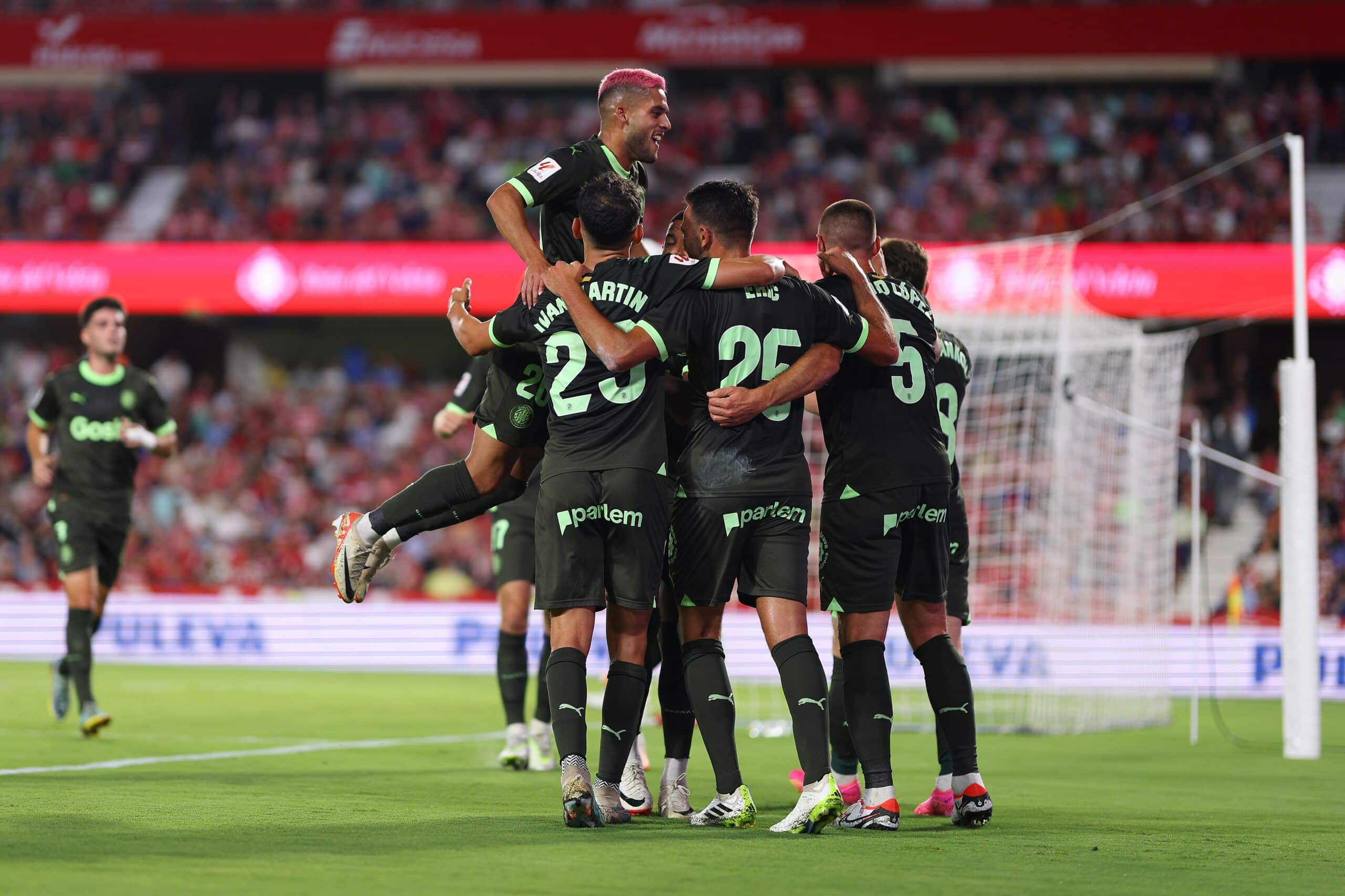 GRANADA, SPAIN - SEPTEMBER 18: David Lopez of Girona celebrates with team mates after scoring the team's third goal during the LaLiga EA Sports match between Granada CF and Girona FC at Estadio Nuevo Los Carmenes on September 18, 2023 in Granada, Spain. (Photo by Fran Santiago/Getty Images)