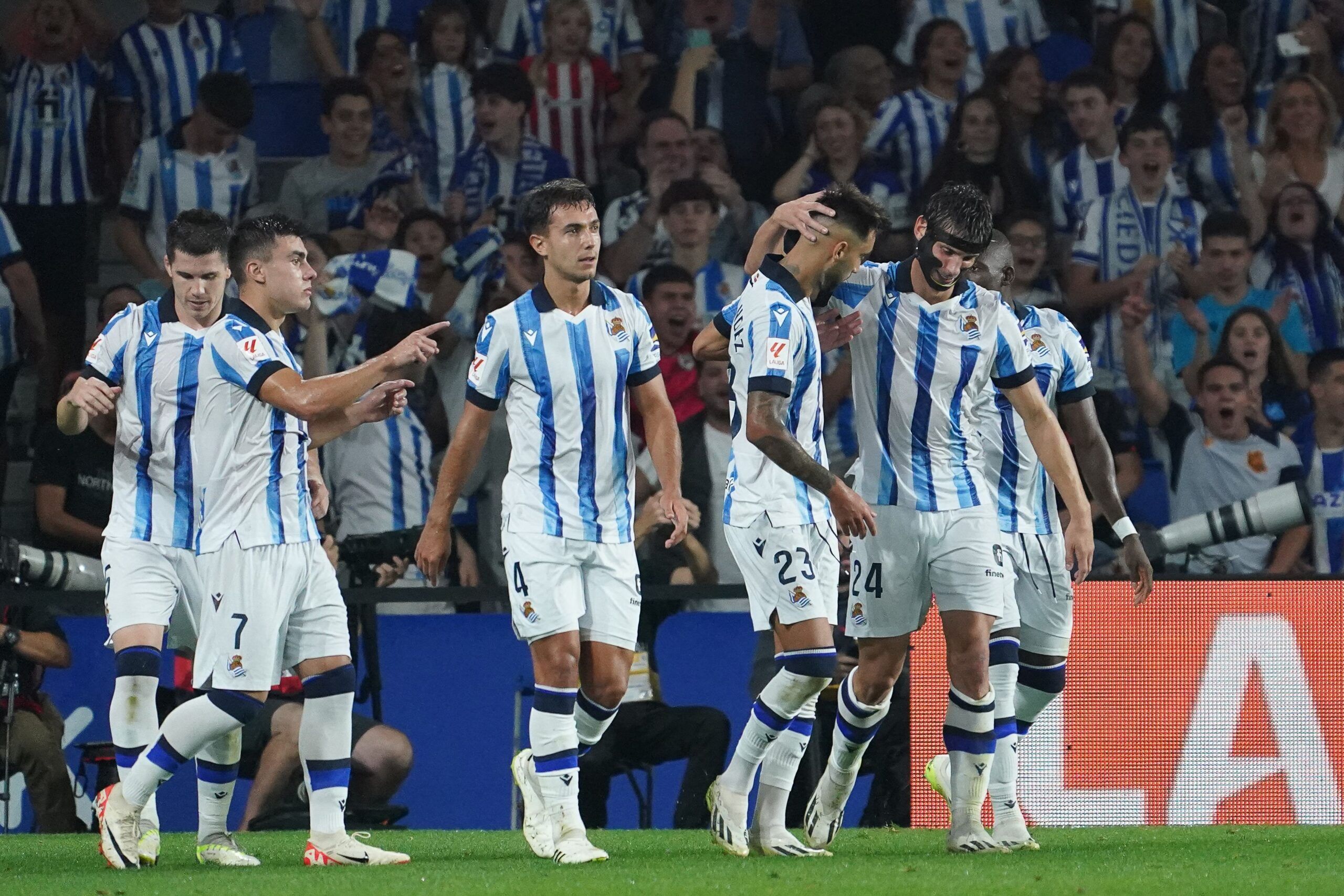Real Sociedad's French defender #24 Robin Le Normand celebrates with teammates after scoring his team's first goal during the Spanish Liga football match between Real Sociedad and Athletic Club Bilbao at the Anoeta stadium in San Sebastian on September 30, 2023. (Photo by CESAR MANSO / AFP) (Photo by CESAR MANSO/AFP via Getty Images)