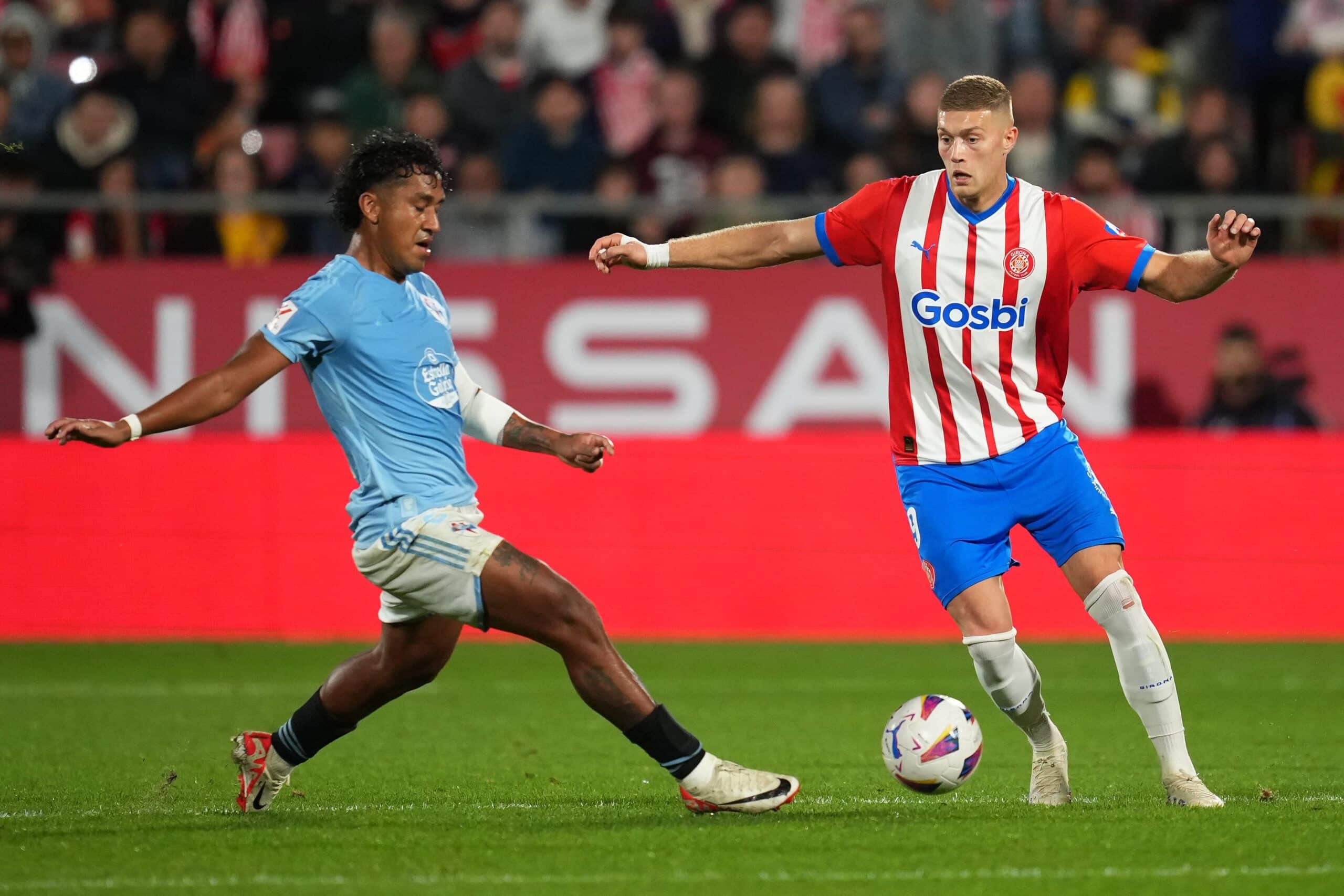 GIRONA, SPAIN - OCTOBER 27: Artem Dovbyk of Girona FC is challenged by Renato Tapia of Celta Vigo during the LaLiga EA Sports match between Girona FC and Celta Vigo at Montilivi Stadium on October 27, 2023 in Girona, Spain. (Photo by Alex Caparros/Getty Images)