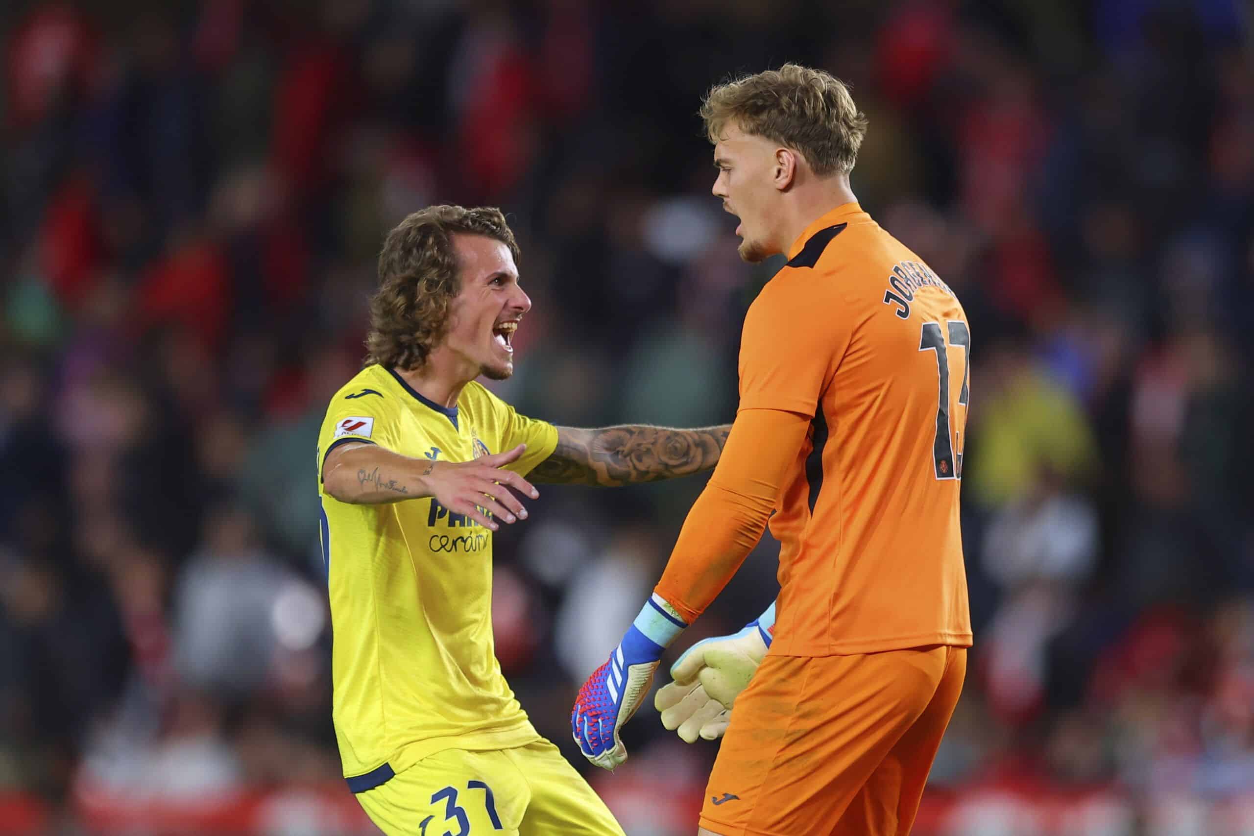 GRANADA, SPAIN - OCTOBER 30: Filip Jorgensen and Carlos Romero of Villarreal CF celebrate after winning the LaLiga EA Sports match between Granada CF and Villarreal CF at Estadio Nuevo Los Carmenes on October 30, 2023 in Granada, Spain. (Photo by Fran Santiago/Getty Images)
