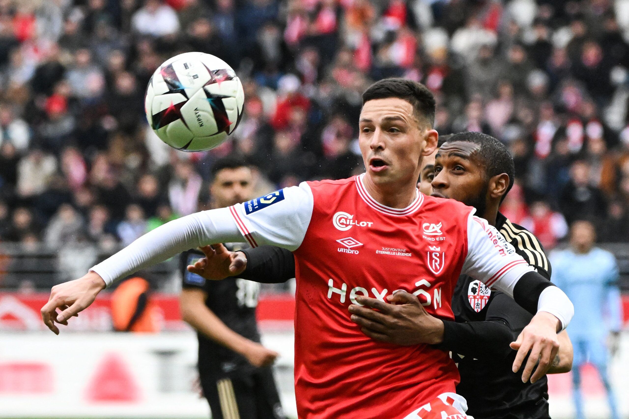 TOPSHOT - Reims' French forward Alexis Flips (L) and Ajaccio's Comorian defender Mohamed Youssouf  go for a header during the French L1 football match between Stade de Reims and AC Ajaccio at Stade Auguste-Delaune in Reims, northern France on March 5, 2023. (Photo by FRANCOIS LO PRESTI / AFP) (Photo by FRANCOIS LO PRESTI/AFP via Getty Images)