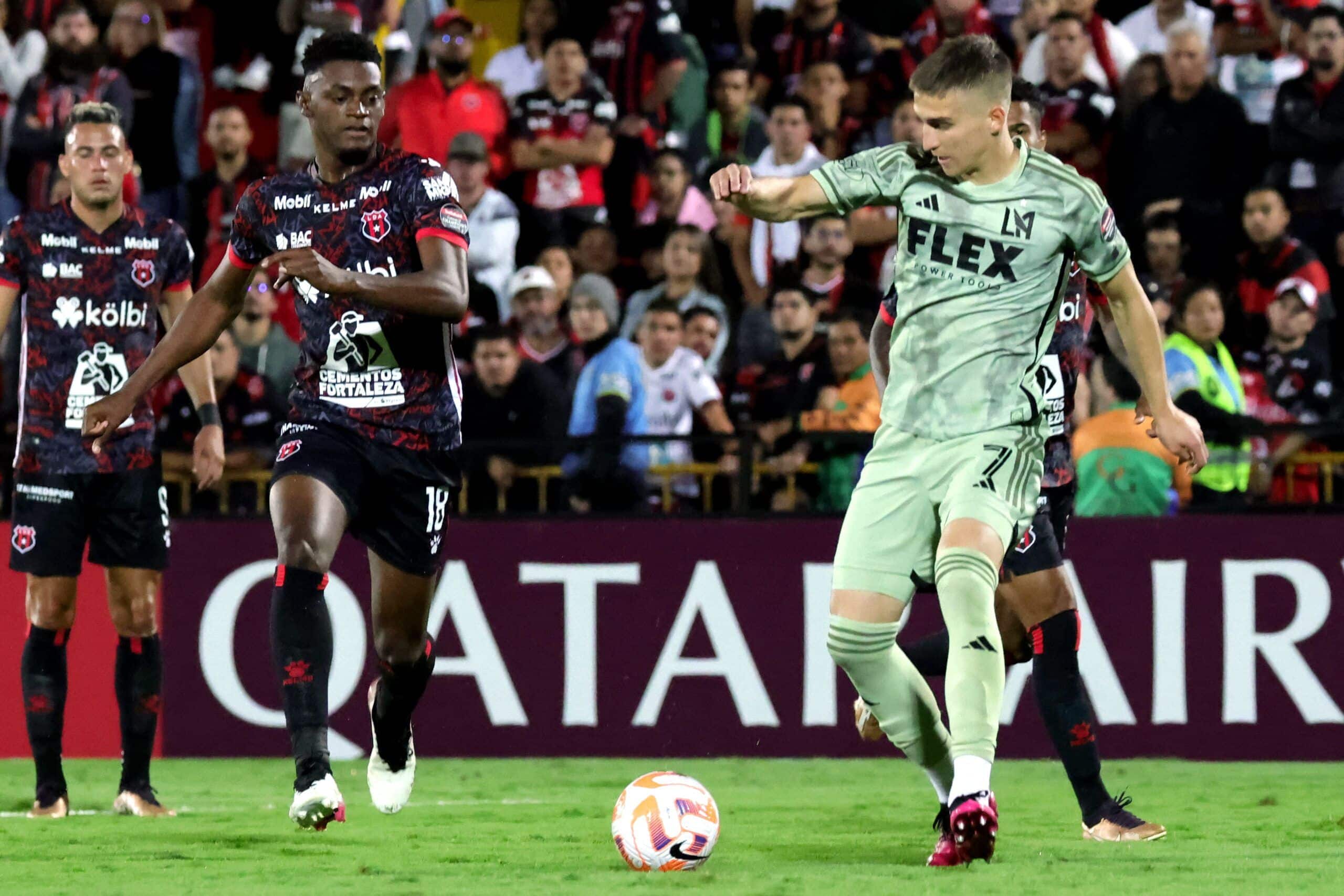 Costa Rica's Alajuelense Sports League (LDA) Costa Rican midfielder Rashir Parkins (L) fights for the ball with USA's Los Angeles Football Club (LAFC) Croatian midfielder Stipe Biuk (R) during the Concacaf Champions League football match between Alajuelense Sports League (LDA) and Los Angeles Football Club (LAFC) at the Alejandro Morera Soto stadium in Alajuela, Costa Rica, March 9, 2023. (Photo by Randall CAMPOS / AFP) (Photo by RANDALL CAMPOS/AFP via Getty Images)
