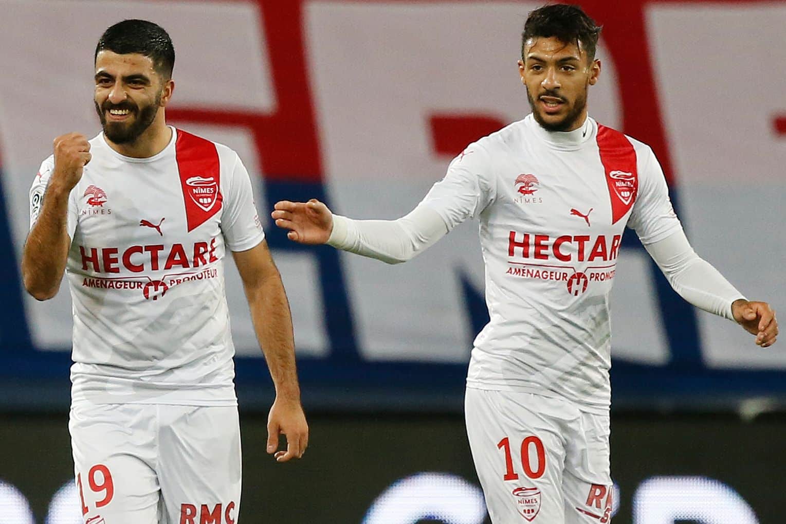 Nimes' Franco-Turkish forward Umut Bozok (L) celebrates after scoring a goal during the French L1 football match between Stade Malherbe Caen and Nimes Olympique at the Michel d'Ornano stadium, in Caen, northwestern France on December 5, 2018. (Photo by CHARLY TRIBALLEAU / AFP)        (Photo credit should read CHARLY TRIBALLEAU/AFP via Getty Images)
