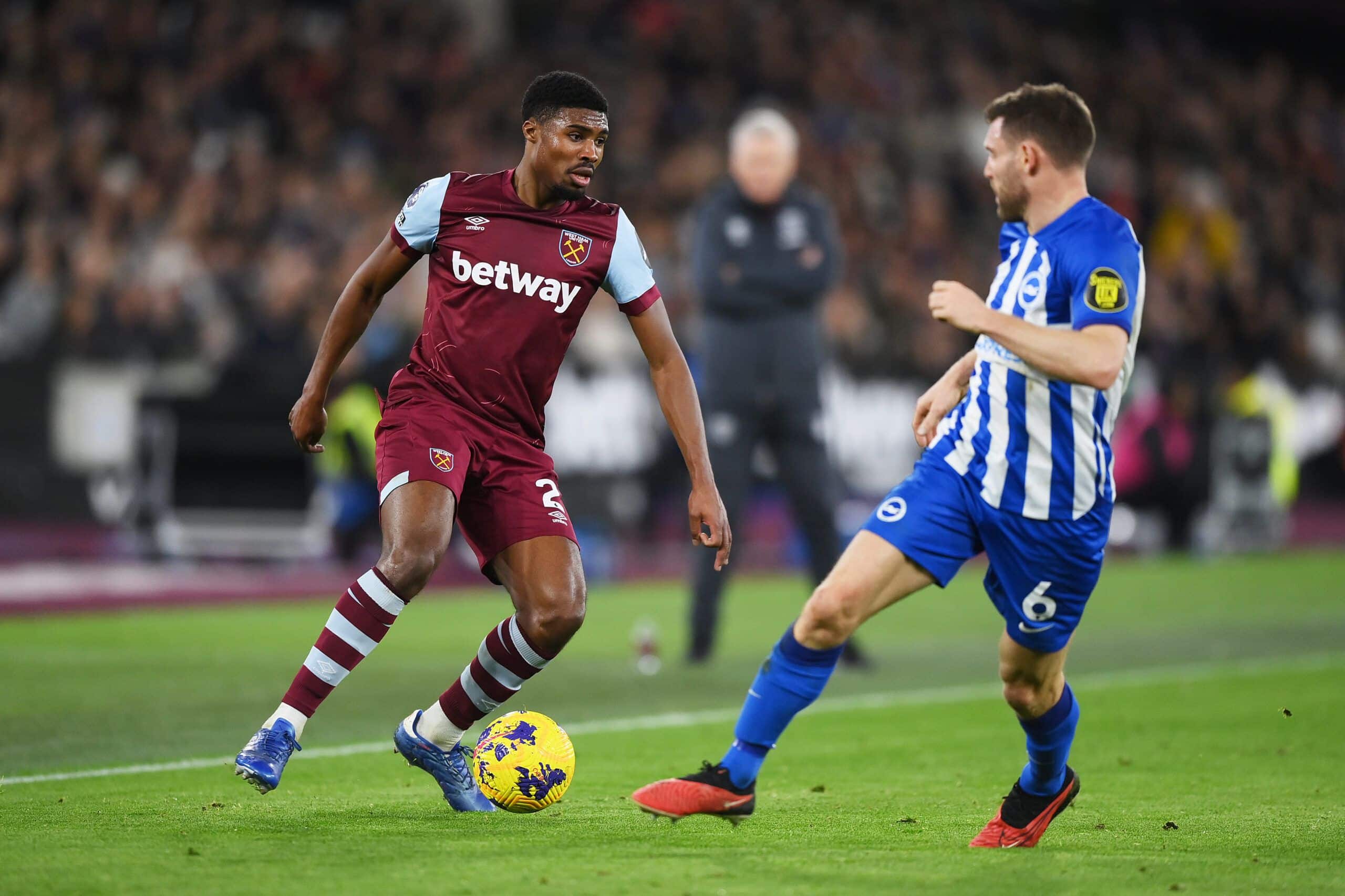 LONDON, ENGLAND - JANUARY 02: Ben Johnson of West Ham United runs with the ball whilst under pressure from James Milner of Brighton & Hove Albion during the Premier League match between West Ham United and Brighton & Hove Albion at London Stadium on January 02, 2024 in London, England. (Photo by Justin Setterfield/Getty Images)