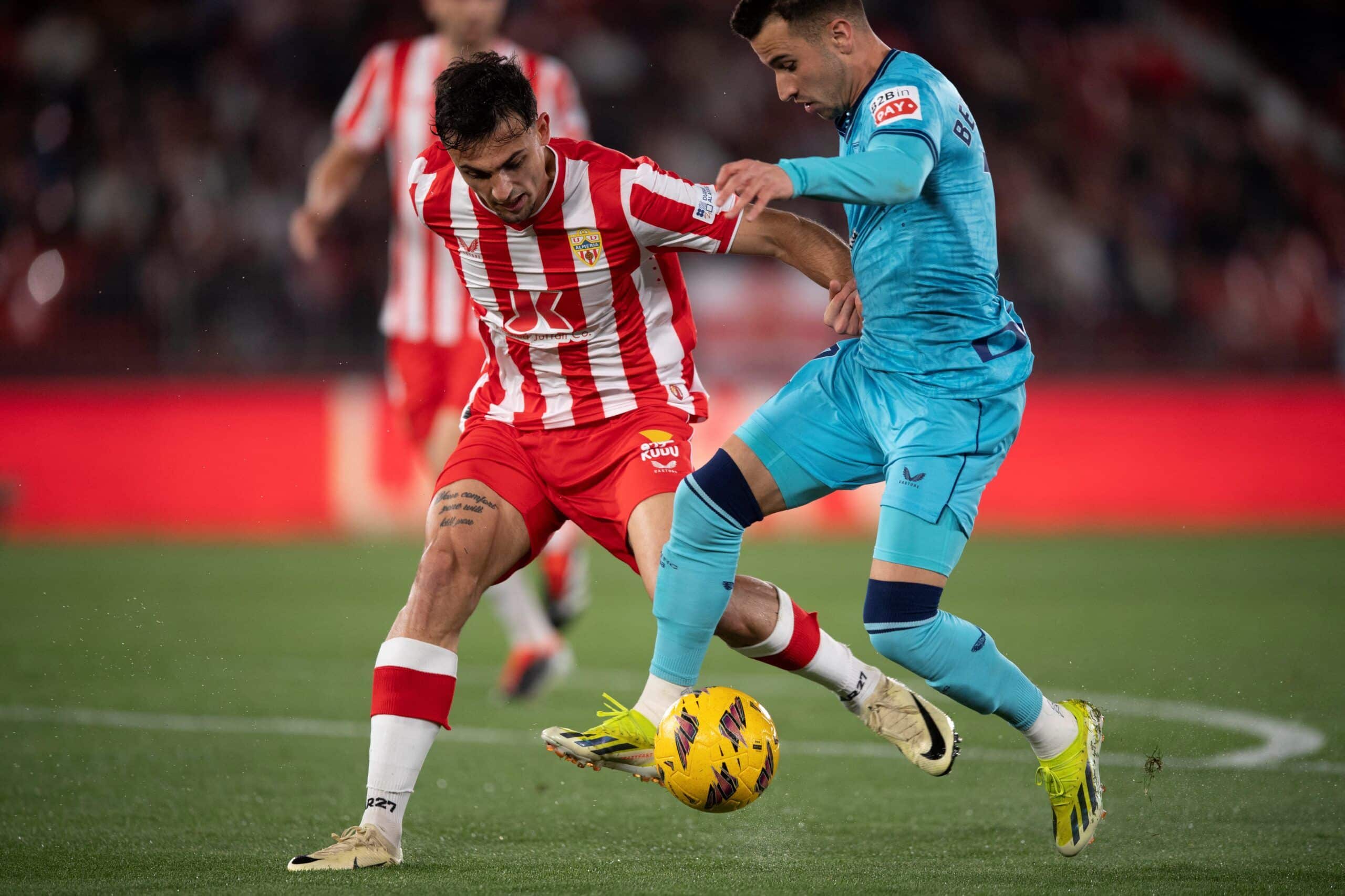 Almeria's Spanish midfielder #18 Marc Pubill (L) fights for the ball with Athletic Bilbao's Spanish forward #7 Alejandro Berenguer during the Spanish league football match between UD Almeria and Athletic Club Bilbao at the Municipal Stadium of the Mediterranean Games in Almeria on February 12, 2024. (Photo by JORGE GUERRERO / AFP) (Photo by JORGE GUERRERO/AFP via Getty Images)