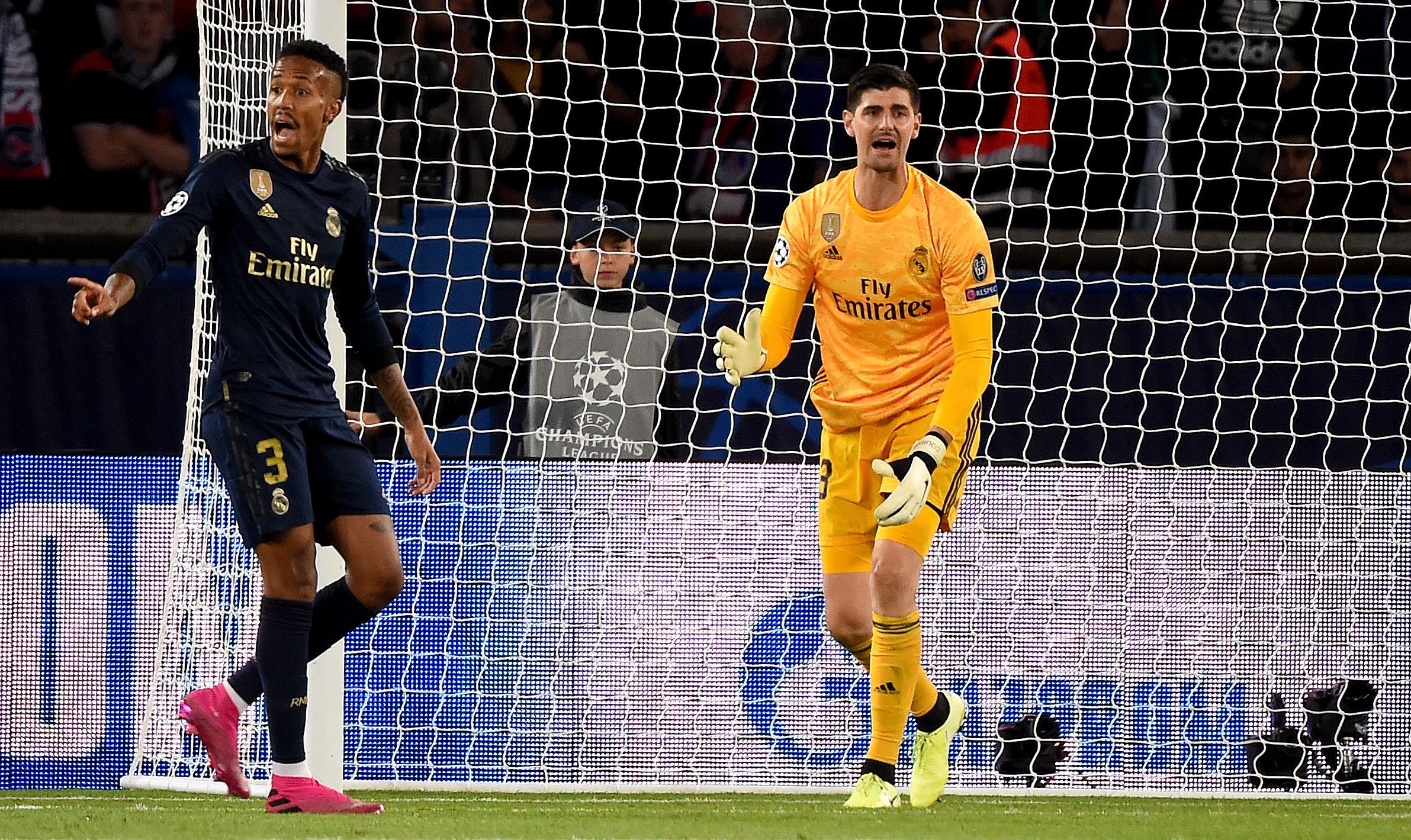 Real Madrid's Belgian goalkeeper Thibaut Courtois (R) reacts  next to his teammate Real Madrid's Brazilian defender Eder Militao during the UEFA Champions league Group A football match between Paris Saint-Germain and Real Madrid, at the Parc des Princes stadium, in Paris, on September 18, 2019. (Photo by Lucas BARIOULET / AFP)        (Photo credit should read LUCAS BARIOULET/AFP via Getty Images)