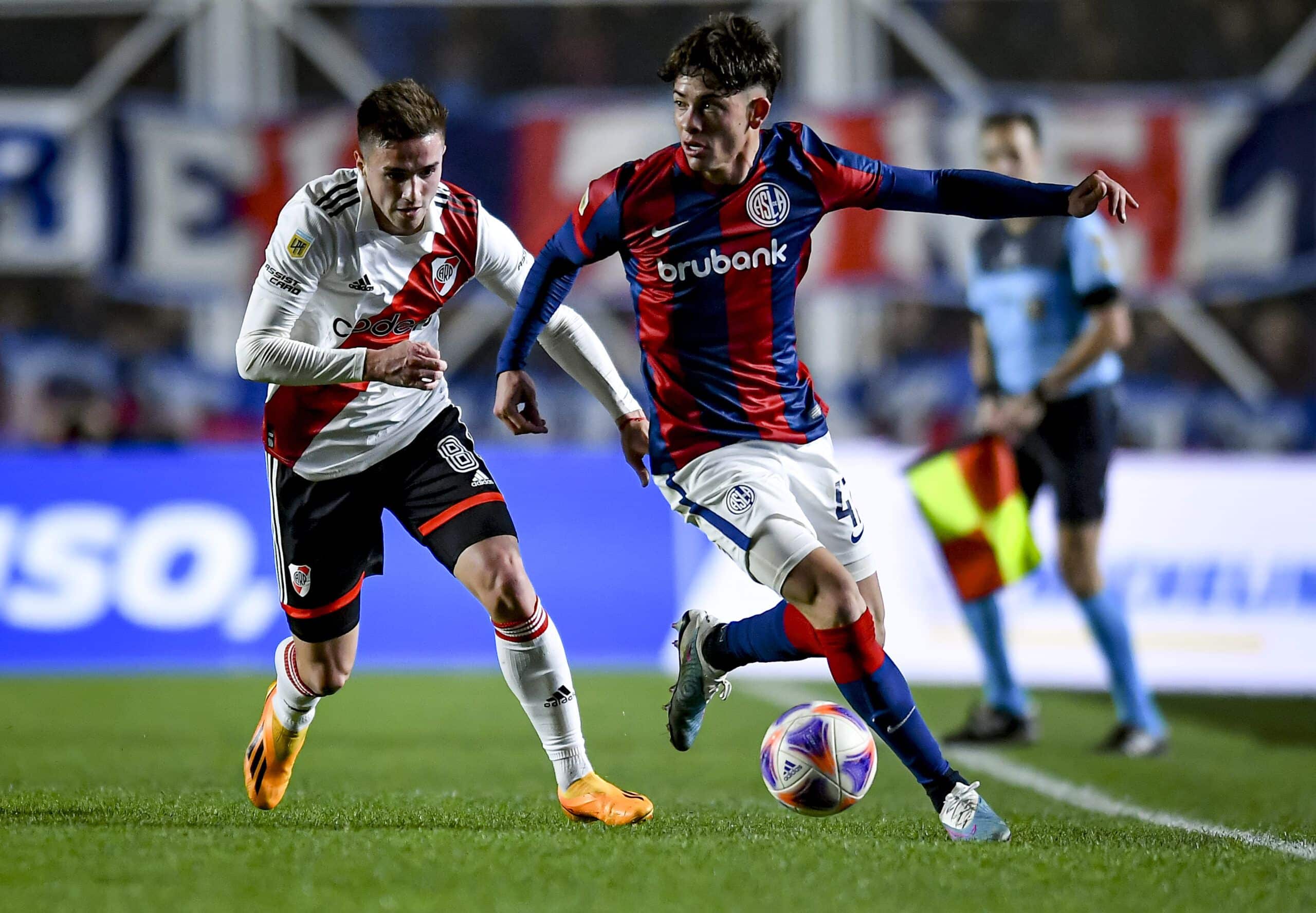 BUENOS AIRES, ARGENTINA - JULY 8: Agustin Giay of San Lorenzo drives the ball against Agustín Palavecino of River Plate during a match between San Lorenzo and River Plate as part of Liga Profesional Argentina 2023 at Pedro Bidegain Stadium on July 8, 2023 in Buenos Aires, Argentina. (Photo by Marcelo Endelli/Getty Images)