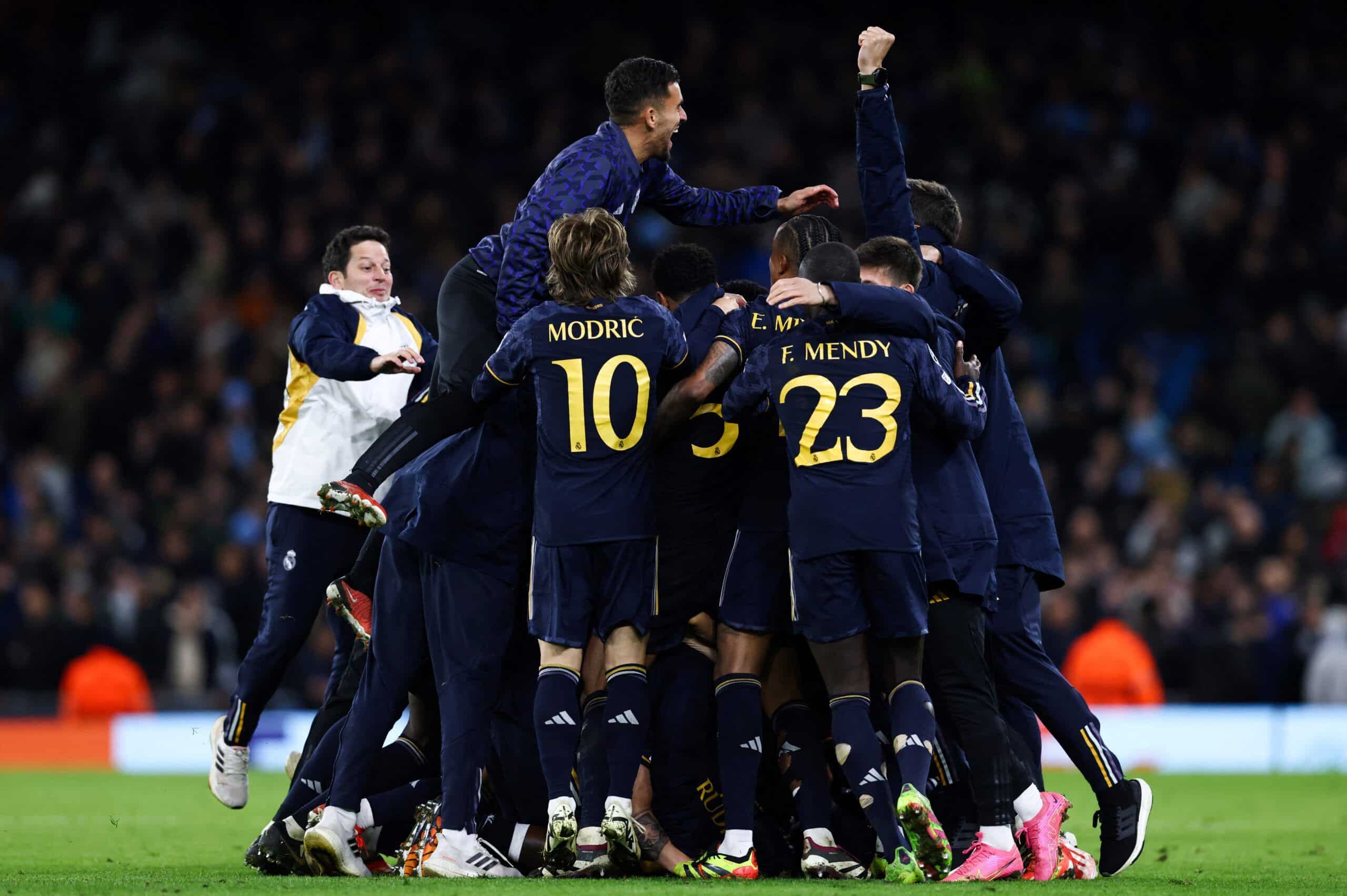 Real Madrid's players celebrate after winning at the end of the UEFA Champions League quarter-final second-leg football match between Manchester City and Real Madrid, at the Etihad Stadium, in Manchester, north-west England, on April 17, 2024. Real Madrid beat holders Manchester City 4-3 on penalties to reach the Champions League semi-finals on Wednesday after the tie ended 4-4 on aggregate. (Photo by Darren Staples / AFP) (Photo by DARREN STAPLES/AFP via Getty Images)