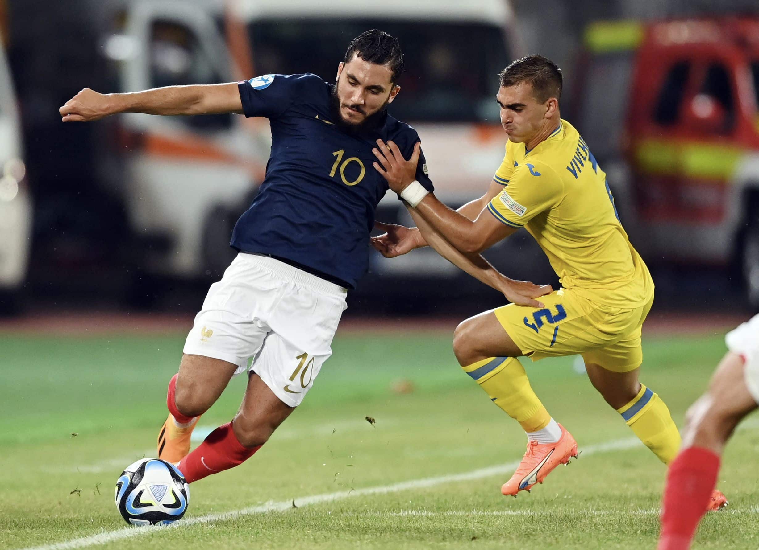 France's forward Rayan Cherki (L) and Ukraine's defender Kostiantyn Vivcharenko vie for the ball during the UEFA European Under-21 Championship Quarter Final football match France vs Ukraine in Cluj-Napoca, Romania, on July 2, 2023. (Photo by MIHAI BARBU / AFP) (Photo by MIHAI BARBU/AFP via Getty Images)