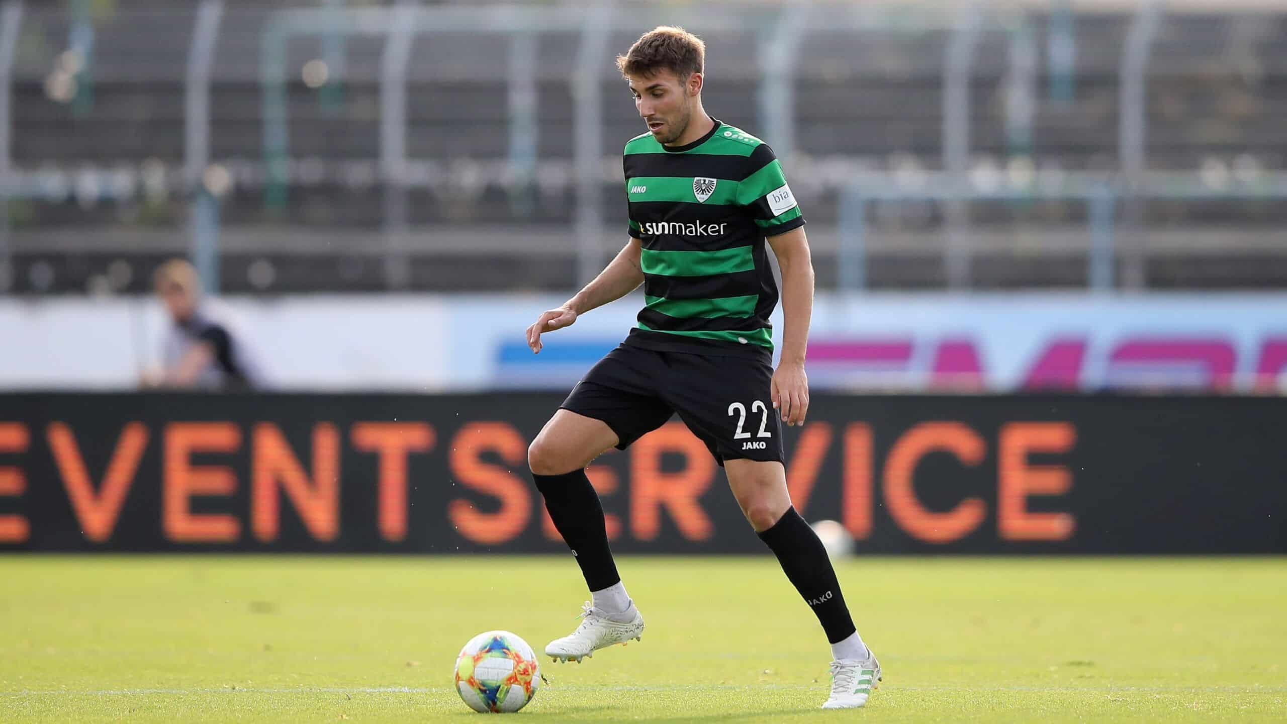 MUENSTER, GERMANY - JULY 01: Okan Erdogan of Muenster runs with the ball during the 3. Liga match between Preussen Muenster and SV Meppen at Preussenstadion on July 01, 2020 in Muenster, Germany. (Photo by Christof Koepsel/Bongarts/Getty Images)