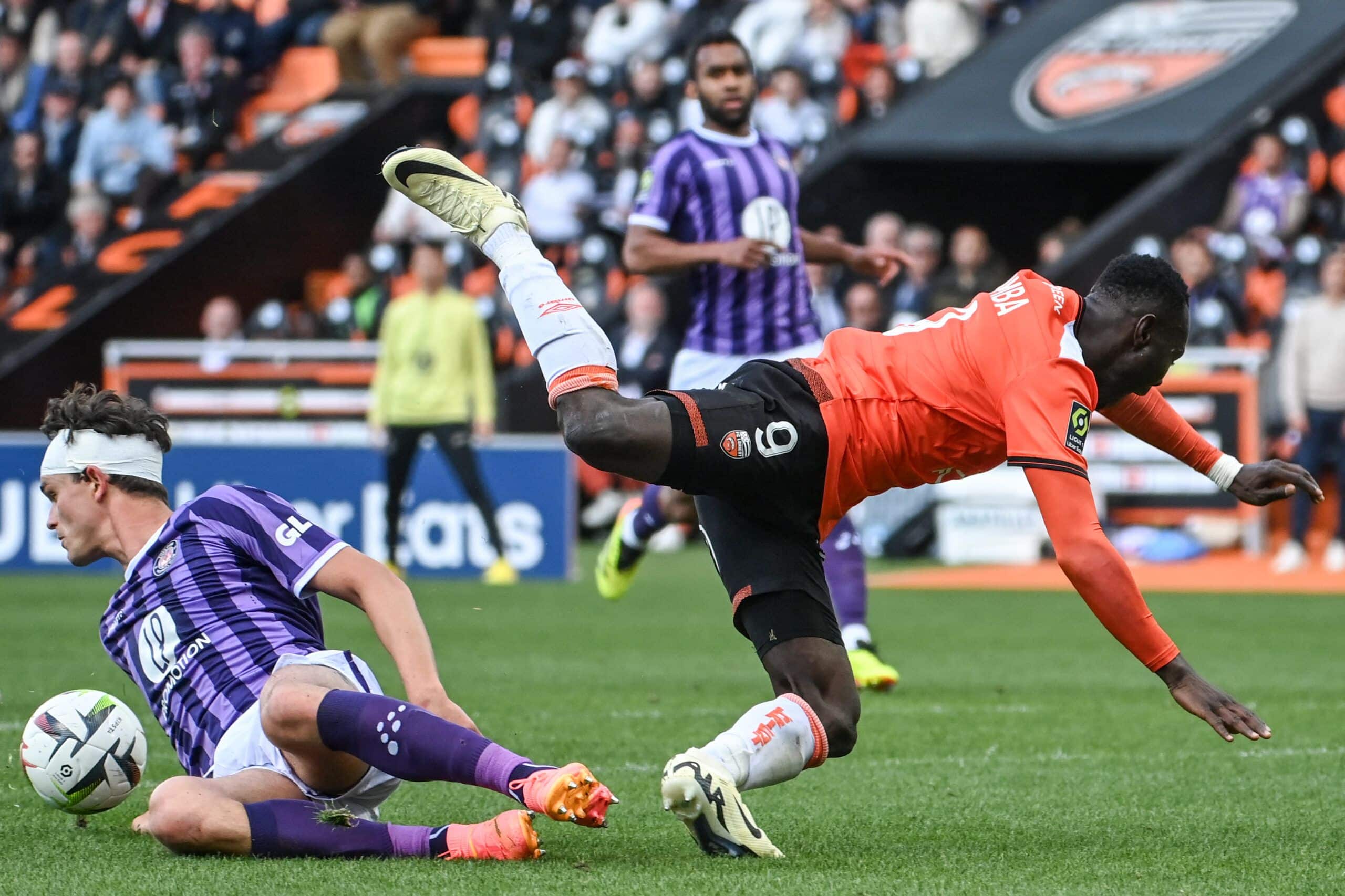 Toulouse's Danish defender #02 Rasmus Nicolaisen (L) fights for the ball with Lorient's Ivorian forward #09 Mohamed Bamba during the French L1 football match between FC Lorient and Toulouse FC at Stade du Moustoir in Lorient, western France, on April 28, 2024. (Photo by Sebastien SALOM-GOMIS / AFP) (Photo by SEBASTIEN SALOM-GOMIS/AFP via Getty Images)
