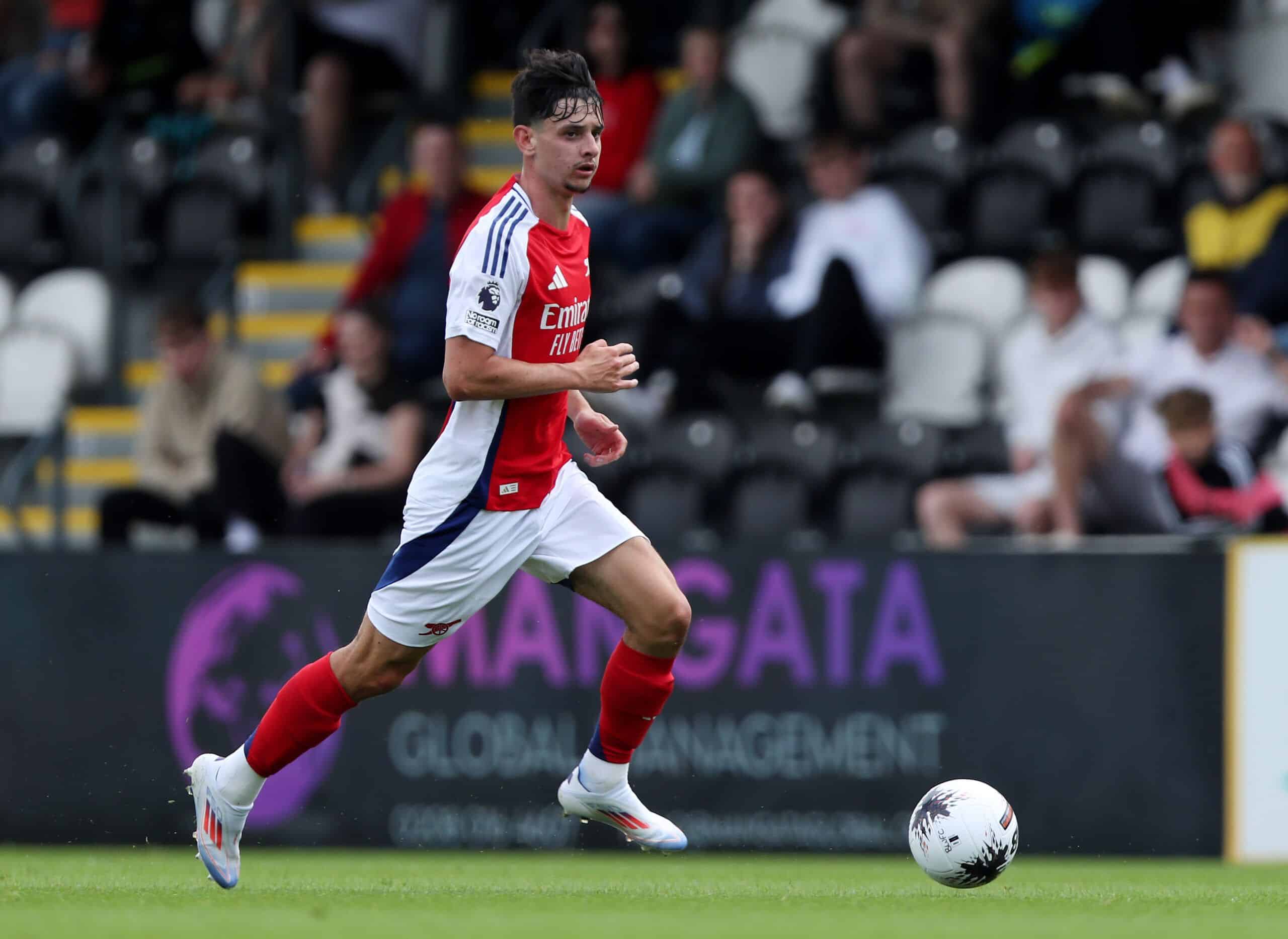 BOREHAMWOOD, ENGLAND - JULY 13: Charlie Patino of Arsenal XI runs with the ball during the Pre-Season Friendly match between Boreham Wood and Arsenal XI at Meadow Park on July 13, 2024 in Borehamwood, England.  (Photo by Ryan Hiscott/Getty Images)