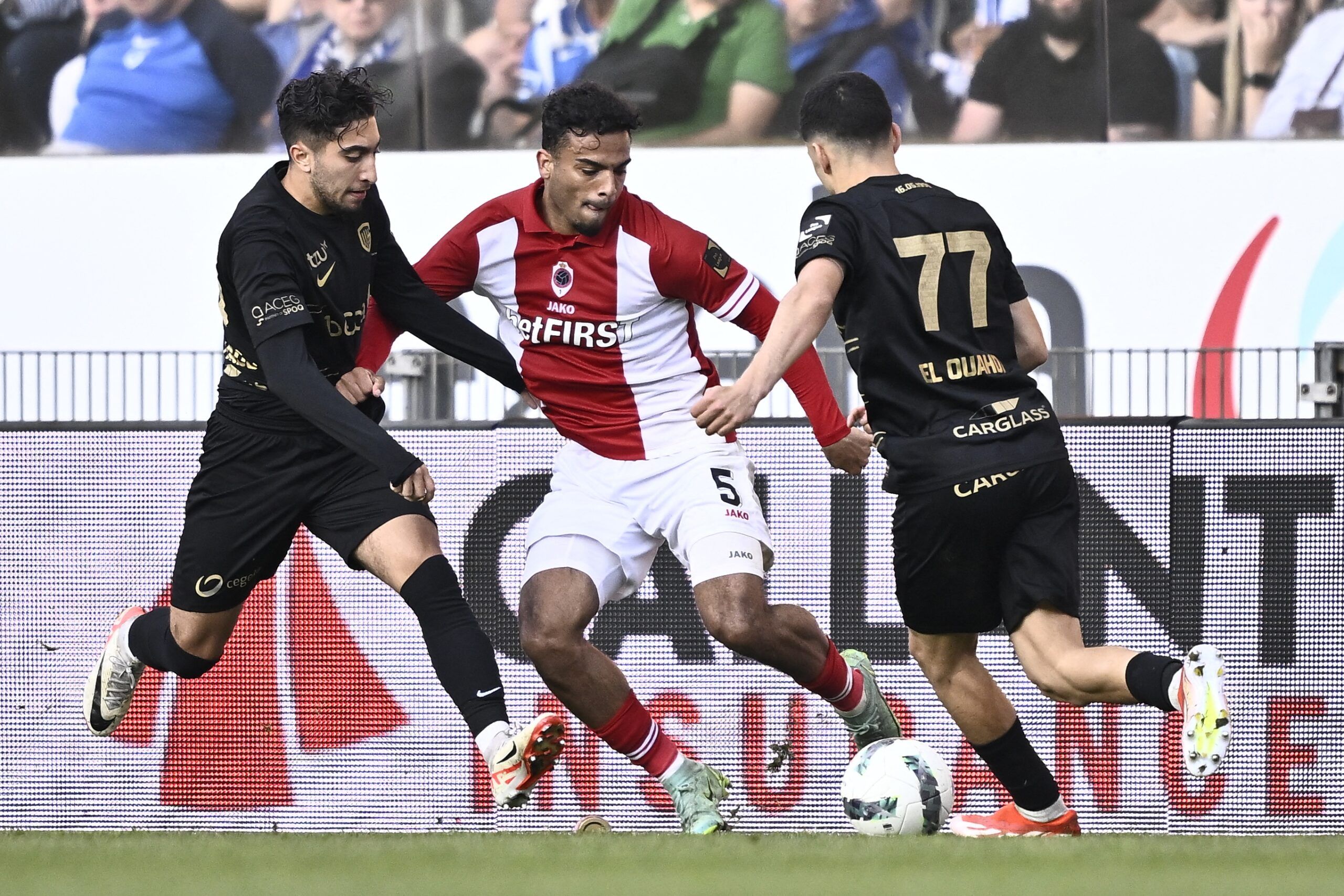 Genk's Belgian midfielder #19 Anouar Ait El Hadj (L), Antwerp's Dutch defender #05 Owen Wijndal (C) and Genk's Moroccan defender #77 Zakaria El Ouahdi fight for the ball during a soccer match between KRC Genk and Royal Antwerp FC, at Cegeka Arena in Genk on May 20, 2024 . (Photo by Johan Eyckens / Belga / AFP) / Belgium OUT (Photo by JOHAN EYCKENS/Belga/AFP via Getty Images)