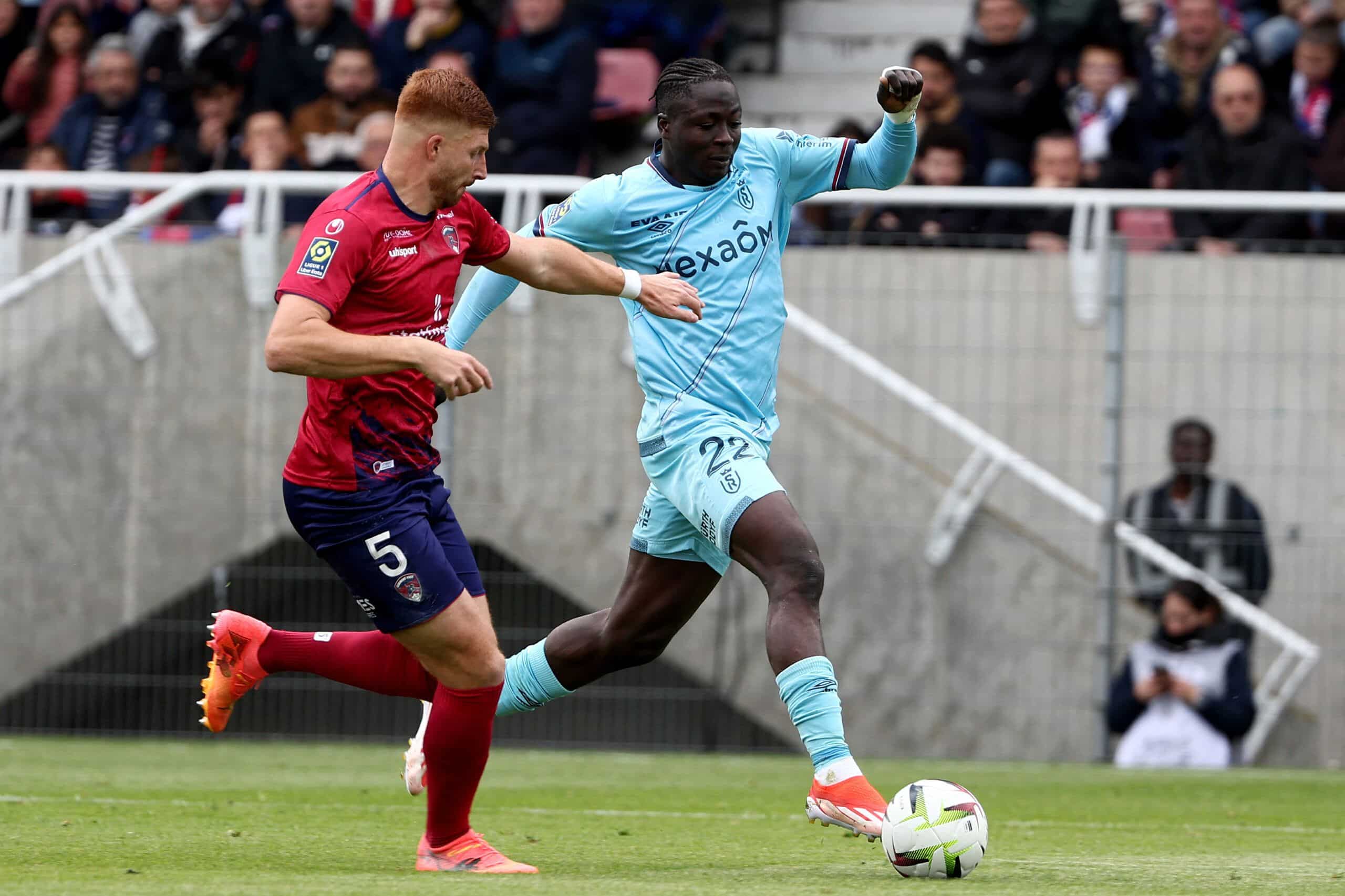 Maximiliano Clermont-Ferrand's Belgian defender #05 Maximiliano Caufriez (L) and Reims' Ivorian forward #22 Oumar Diakite fight for the ball during the French L1 football match between Clermont Foot 63 and Stade de Reims at the Gabriel Montpied stadium in Clermont-Ferrand, central France, on April 28, 2024. (Photo by ROMAIN PERROCHEAU / AFP) (Photo by ROMAIN PERROCHEAU/AFP via Getty Images)