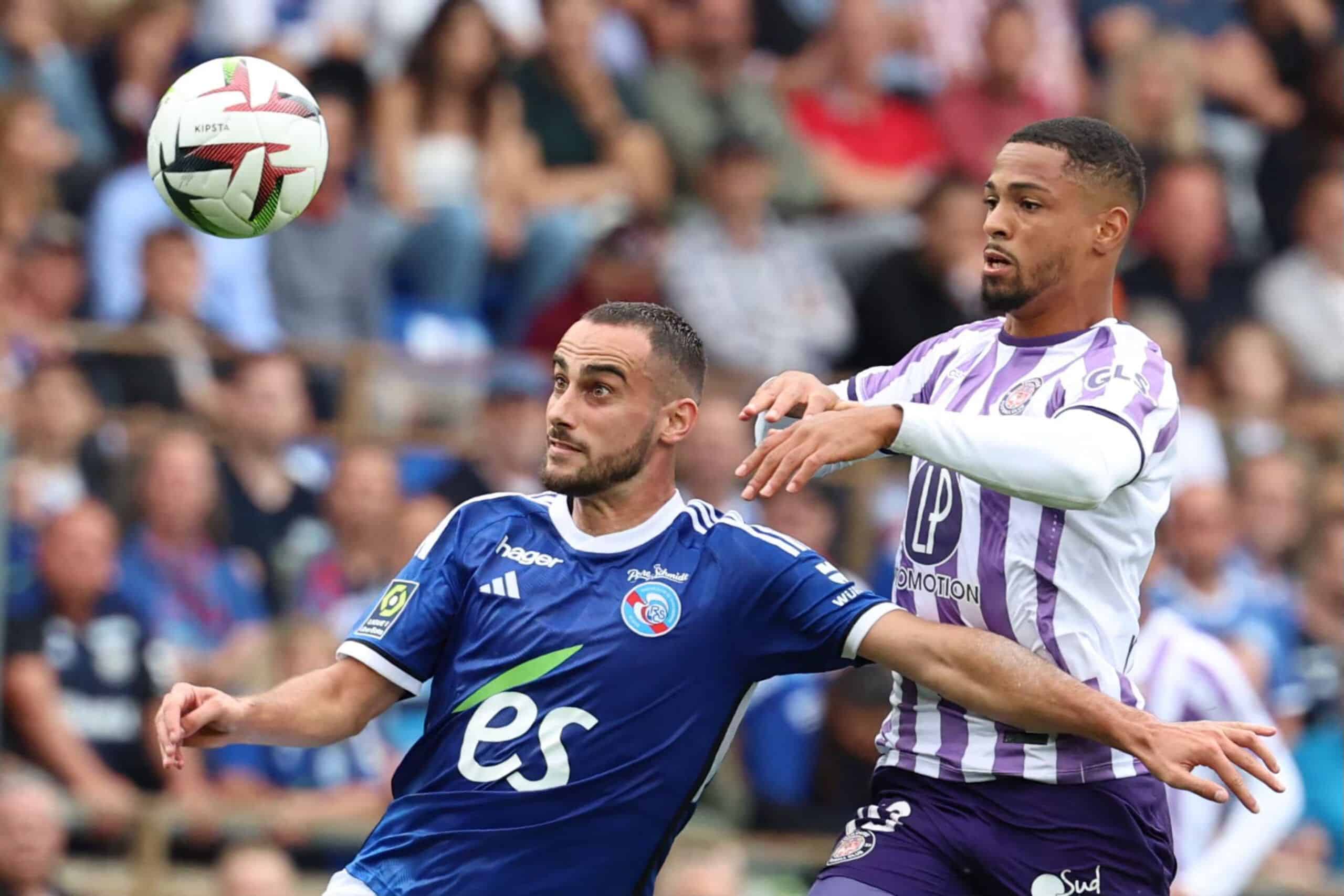 Toulouse's French forward #19 Franck Magri (R) fights for the ball with Strasbourg's French defender #05 Lucas Perrin during the French L1 football match between RC Strasbourg Alsace and Toulouse FC at Stade de la Meinau in Strasbourg, eastern France on August 27, 2023. (Photo by Frederick FLORIN / AFP) (Photo by FREDERICK FLORIN/AFP via Getty Images)