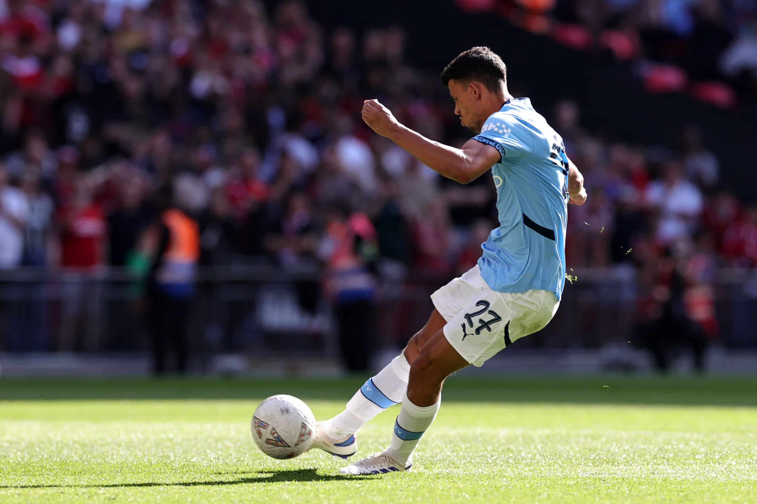 LONDON, ENGLAND - AUGUST 10: Matheus Nunes of Manchester City scores the team's sixth penalty in the penalty shoot out  during the 2024 FA Community Shield match between Manchester United and Manchester City at Wembley Stadium on August 10, 2024 in London, England. (Photo by David Rogers/Getty Images)