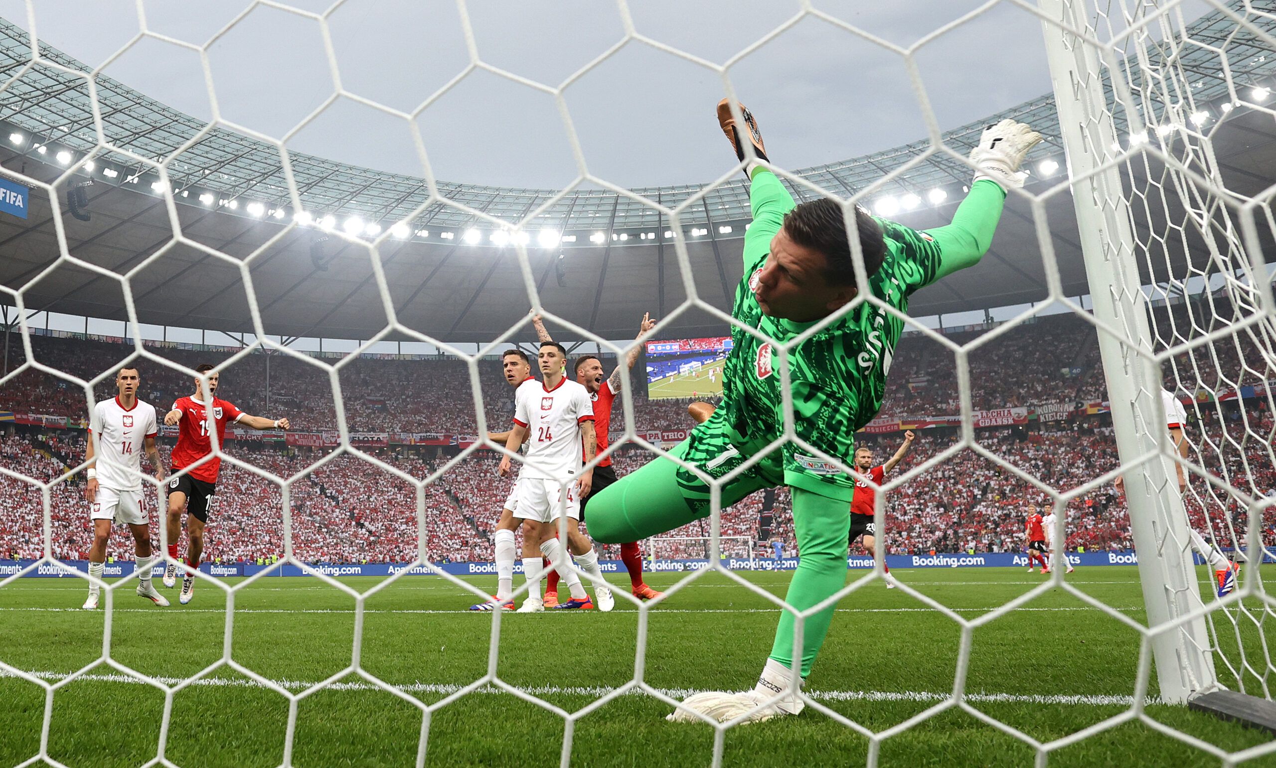 BERLIN, GERMANY - JUNE 21: (EDITORS NOTE: Image was captured using a static remote camera behind the goal.) Wojciech Szczesny of Poland fails to save a headed shot from Gernot Trauner of Austria (not pictured), resulting in the first goal for Austria during the UEFA EURO 2024 group stage match between Poland and Austria at Olympiastadion on June 21, 2024 in Berlin, Germany. (Photo by Julian Finney/Getty Images)
