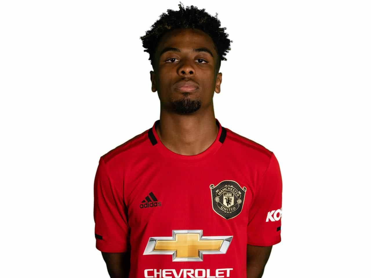 Angel Gomes poses in the 2019-20 Manchester United home kit. Credit: Manchester United
