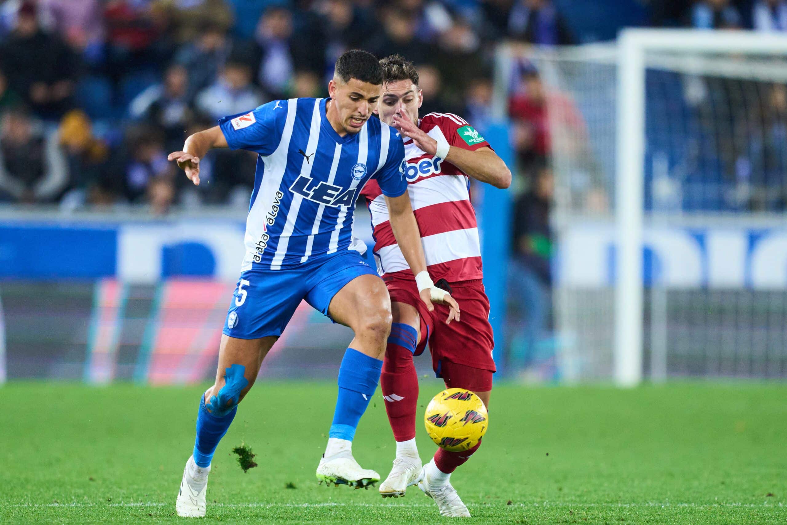 VITORIA-GASTEIZ, SPAIN - NOVEMBER 24: Abdel Abqar of Deportivo Alaves duels for the ball with Lucas Boye of Granada CF during the LaLiga EA Sports match between Deportivo Alaves and Granada CF at Estadio de Mendizorroza on November 24, 2023 in Vitoria-Gasteiz, Spain. (Photo by Juan Manuel Serrano Arce/Getty Images)