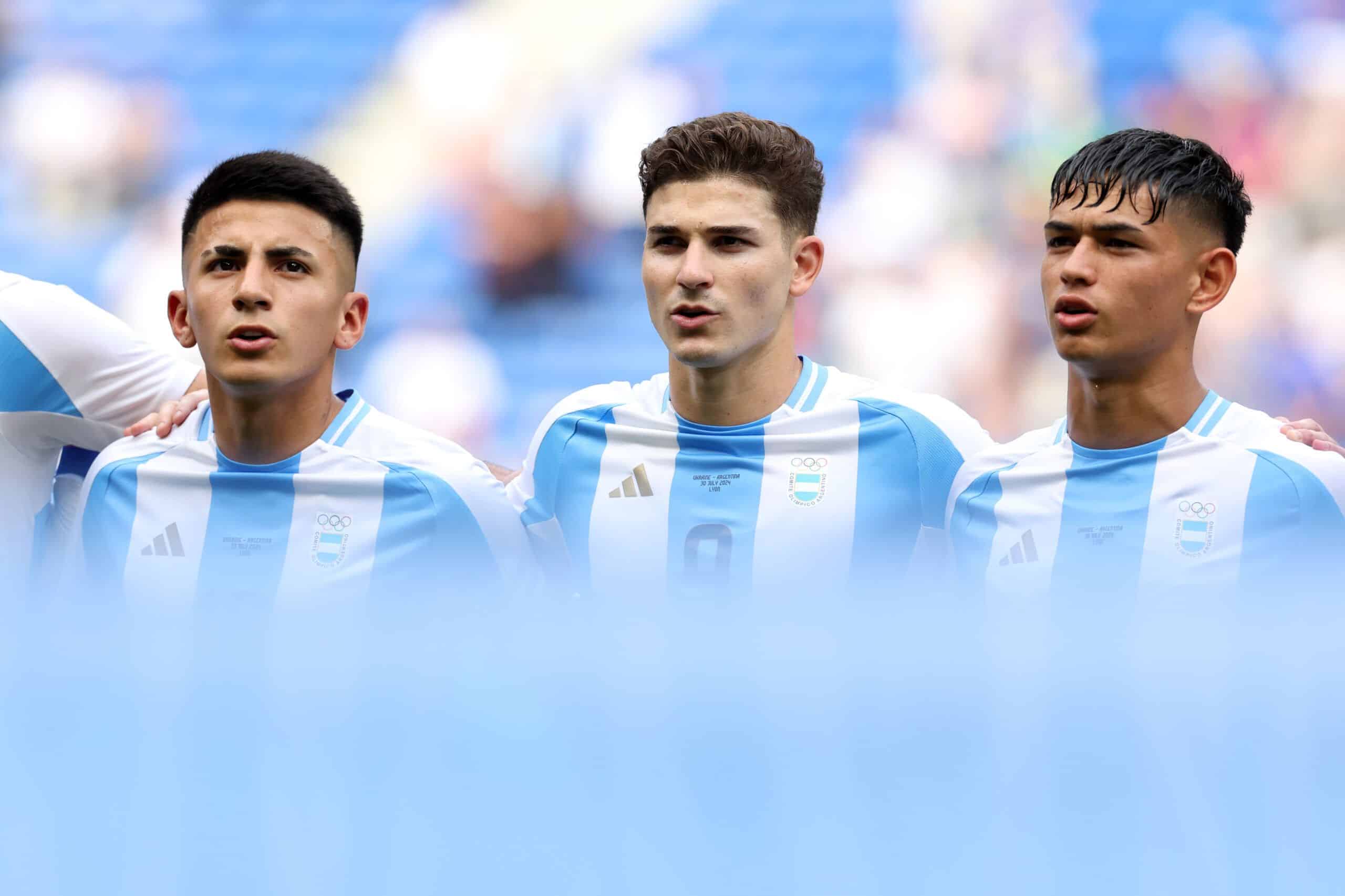 LYON, FRANCE - JULY 30: Thiago Almada #10, Julian Alvarez #9 and Julio Soler of Team Argentina sing national anthem prior to the Men's group B match between Ukraine and Argentina during the Olympic Games Paris 2024 at Stade de Lyon on July 30, 2024 in Lyon, France. (Photo by Claudio Villa/Getty Images)
