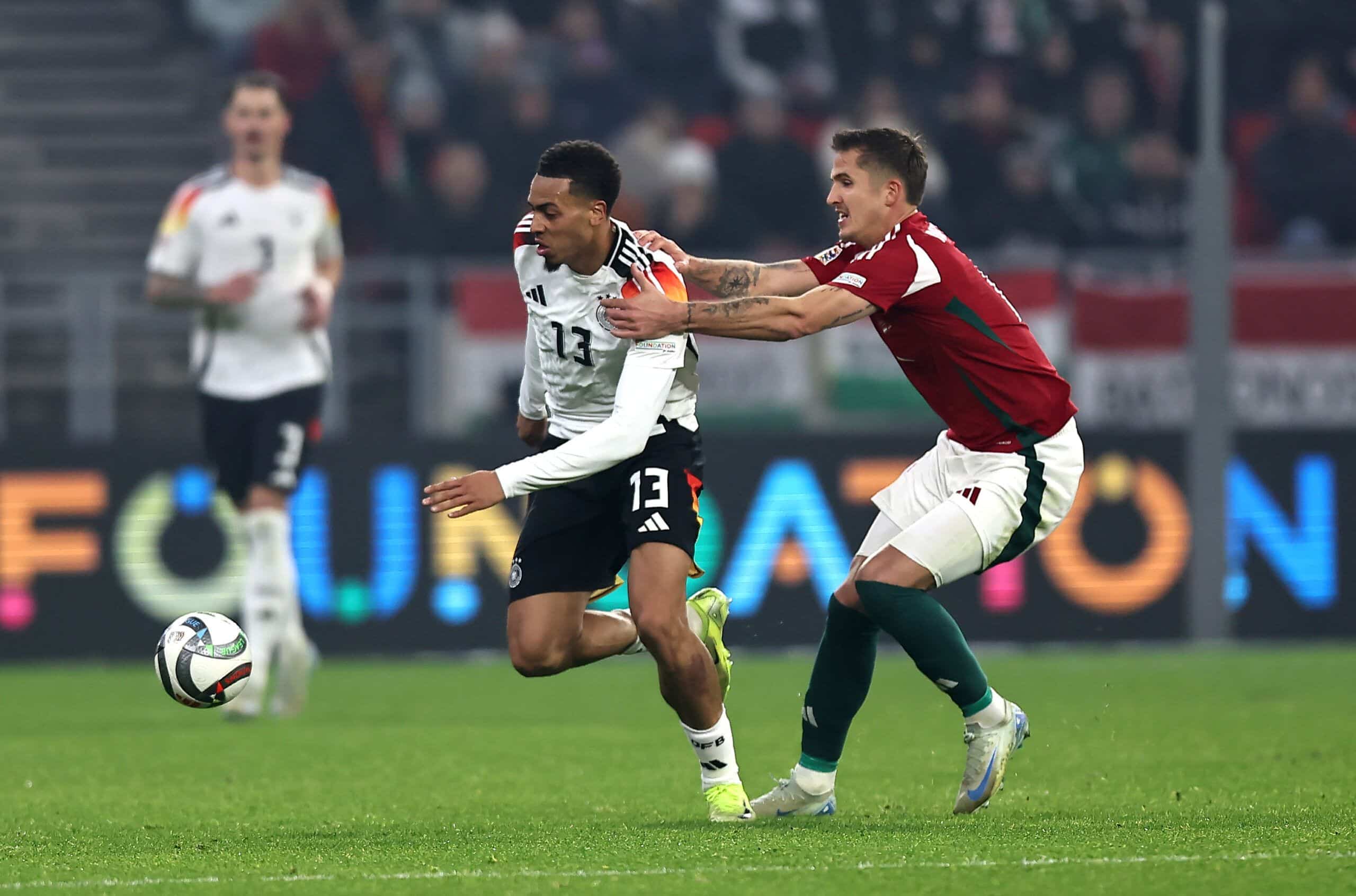 BUDAPEST, HUNGARY - NOVEMBER 19: Felix Nmecha of Germany chases a loose ball whilst under pressure from Tamas Nikitscher of Hungary during the UEFA Nations League 2024/25 League A Group A3 match between Hungary and Germany at  on November 19, 2024 in Budapest, Hungary. (Photo by David Balogh/Getty Images)